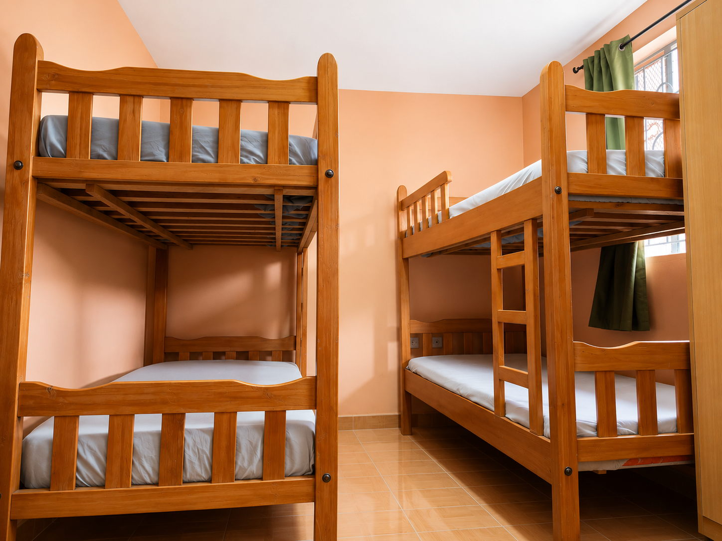 Tidy student hostel room with wooden bunk beds at EMESA